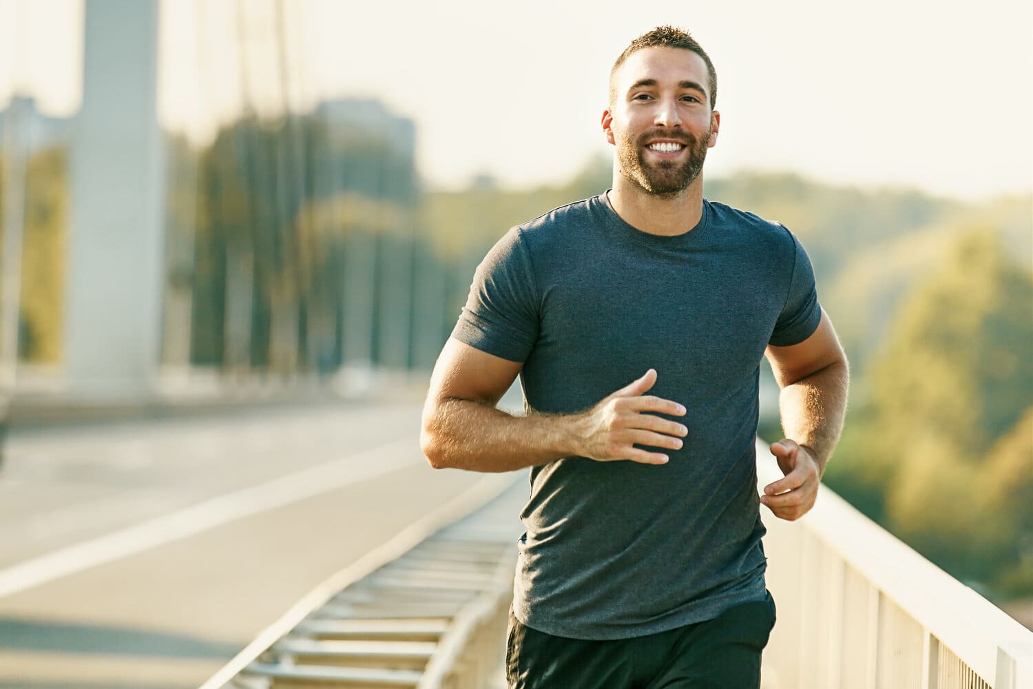 Handsome,Young,Man,Running,Across,The,Bridge.