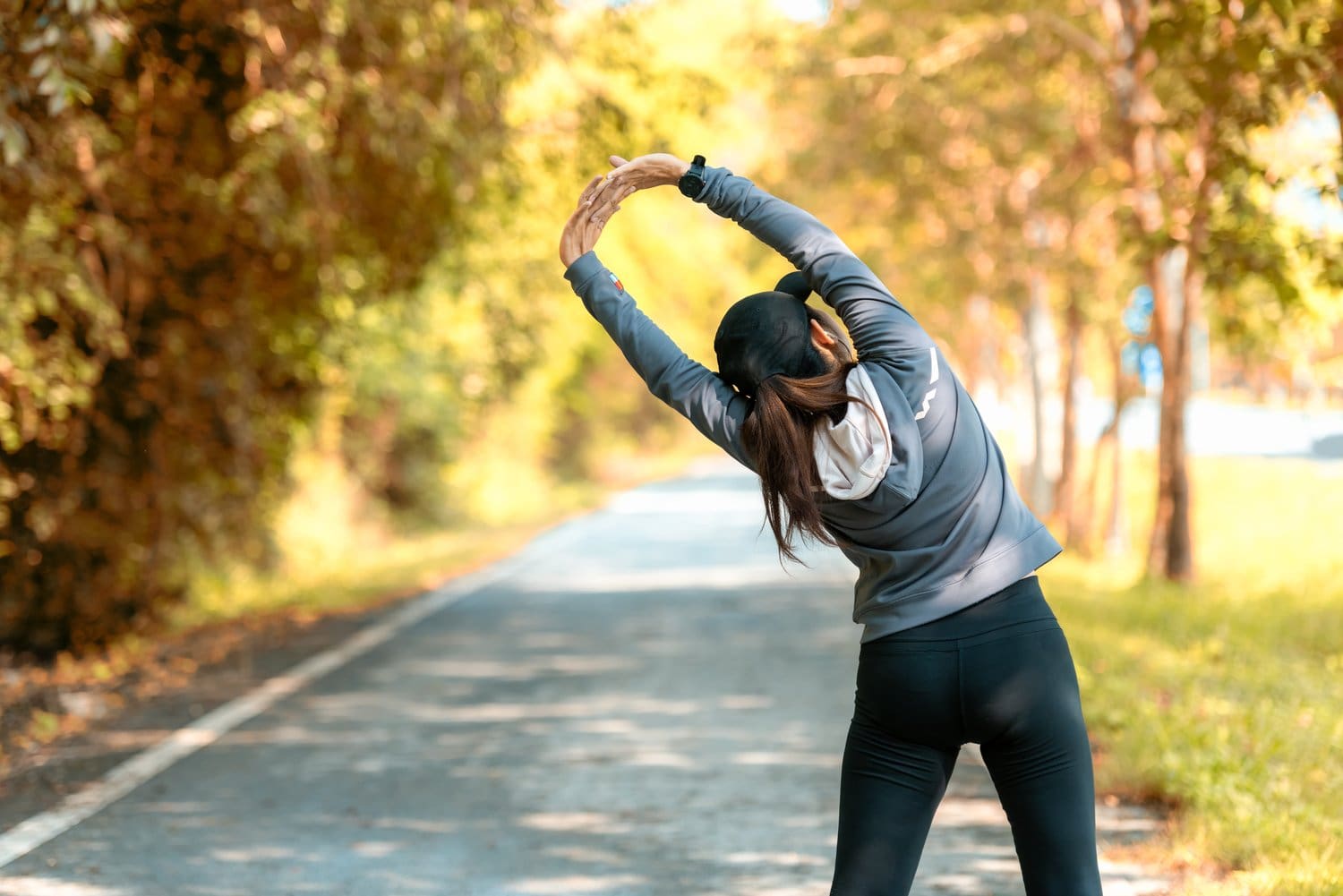 Healthy,Young,Woman,Warming,Up,Stretching,Her,Arms,And,Looking